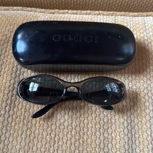 Gucci oval sunglasses in amber/green color with case.
